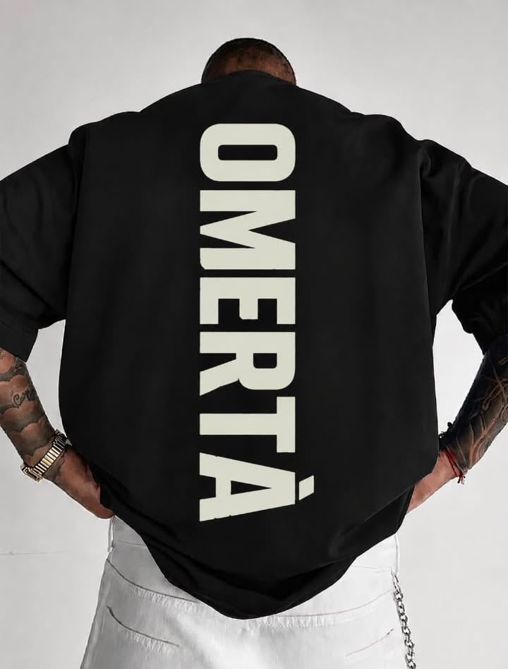 Black oversized tee with large vertical OMERTÀ back print