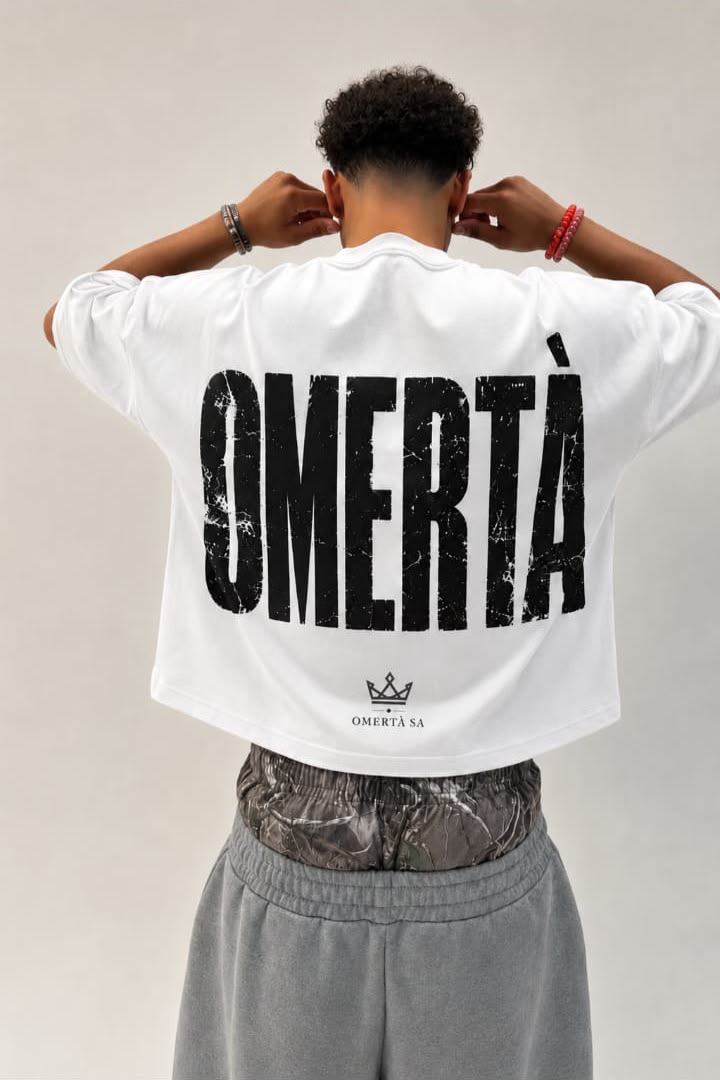 White oversized Omertà tee with large distressed back print and crown emblem
