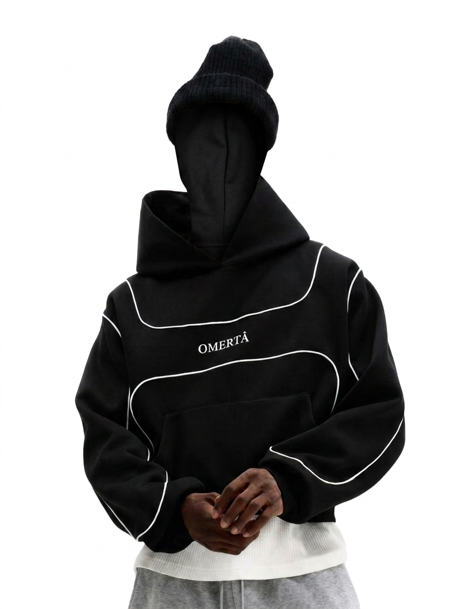 Black Omertà hoodie with white contrast piping worn with a beanie